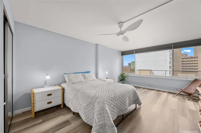 a spacious bedroom with a bed and a large window