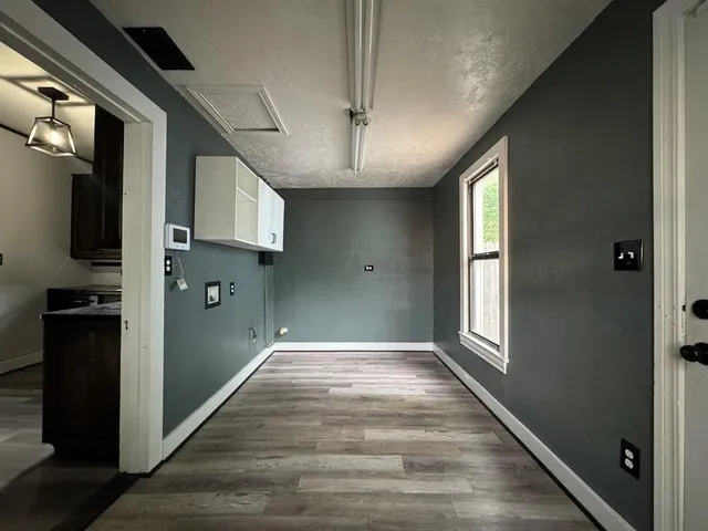 a view of hallway with stairs and wooden floor