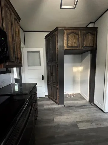 a kitchen with a refrigerator and a stove top oven
