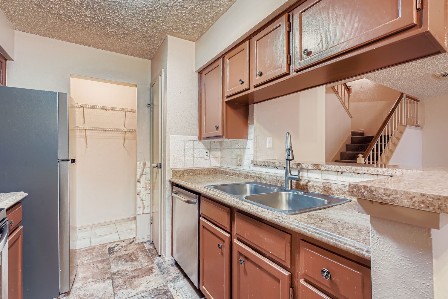 3100 Jeanetta Street, Unit 602 Houston, TX 77063 - Photo 11 of 34 a kitchen with stainless steel appliances granite countertop a sink and a refrigerator