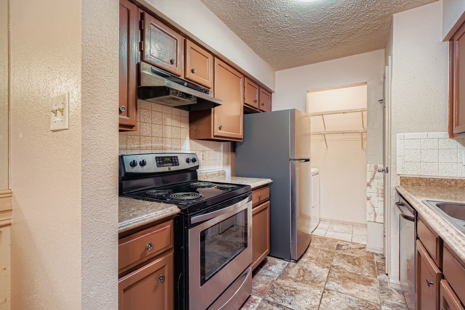 3100 Jeanetta Street, Unit 602 Houston, TX 77063 - Photo 12 of 34 a kitchen with stainless steel appliances granite countertop a stove and a refrigerator