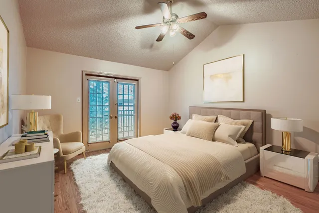 a bedroom with a balcony a bed and a chandelier