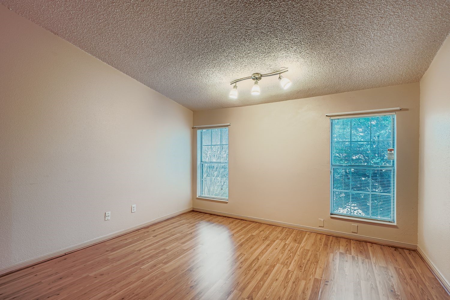 3100 Jeanetta Street, Unit 602 Houston, TX 77063 - Photo 24 of 34 an empty room with wooden floor chandelier and windows