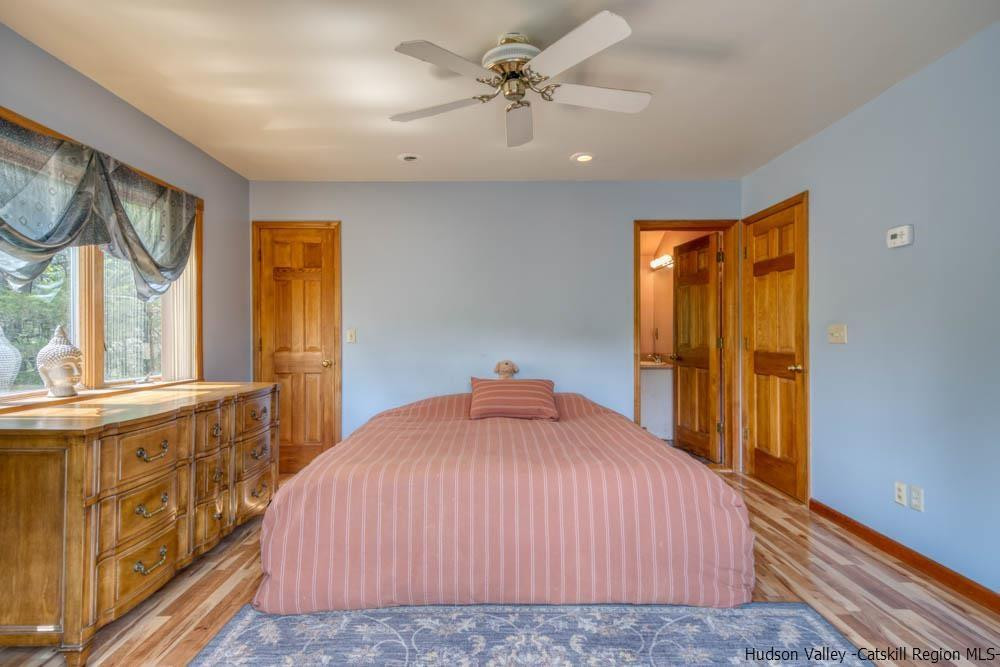 686 Berme Road High Falls, NY 12440 - Photo 14 of 23 a bedroom with a bed and wooden floor