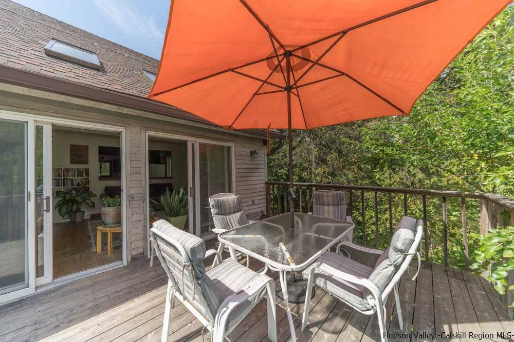 686 Berme Road High Falls, NY 12440 - Photo 23 of 23 a patio with a table and chairs under an umbrella