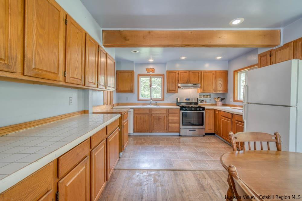 686 Berme Road High Falls, NY 12440 - Photo 7 of 23 a kitchen with granite countertop a sink stainless steel appliances and cabinets