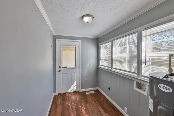a view of a livingroom with wooden floor and windows