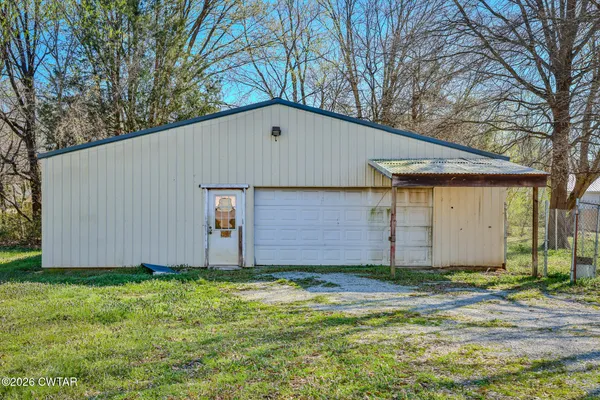 a front view of house with yard and trees