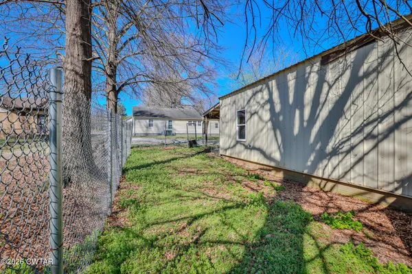 a view of a backyard with a tree