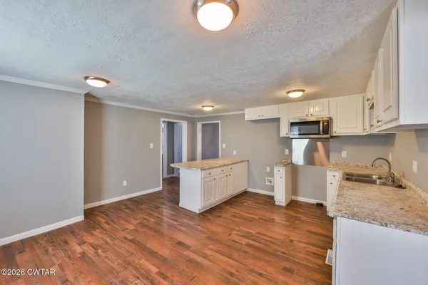 a kitchen with a sink window and cabinets