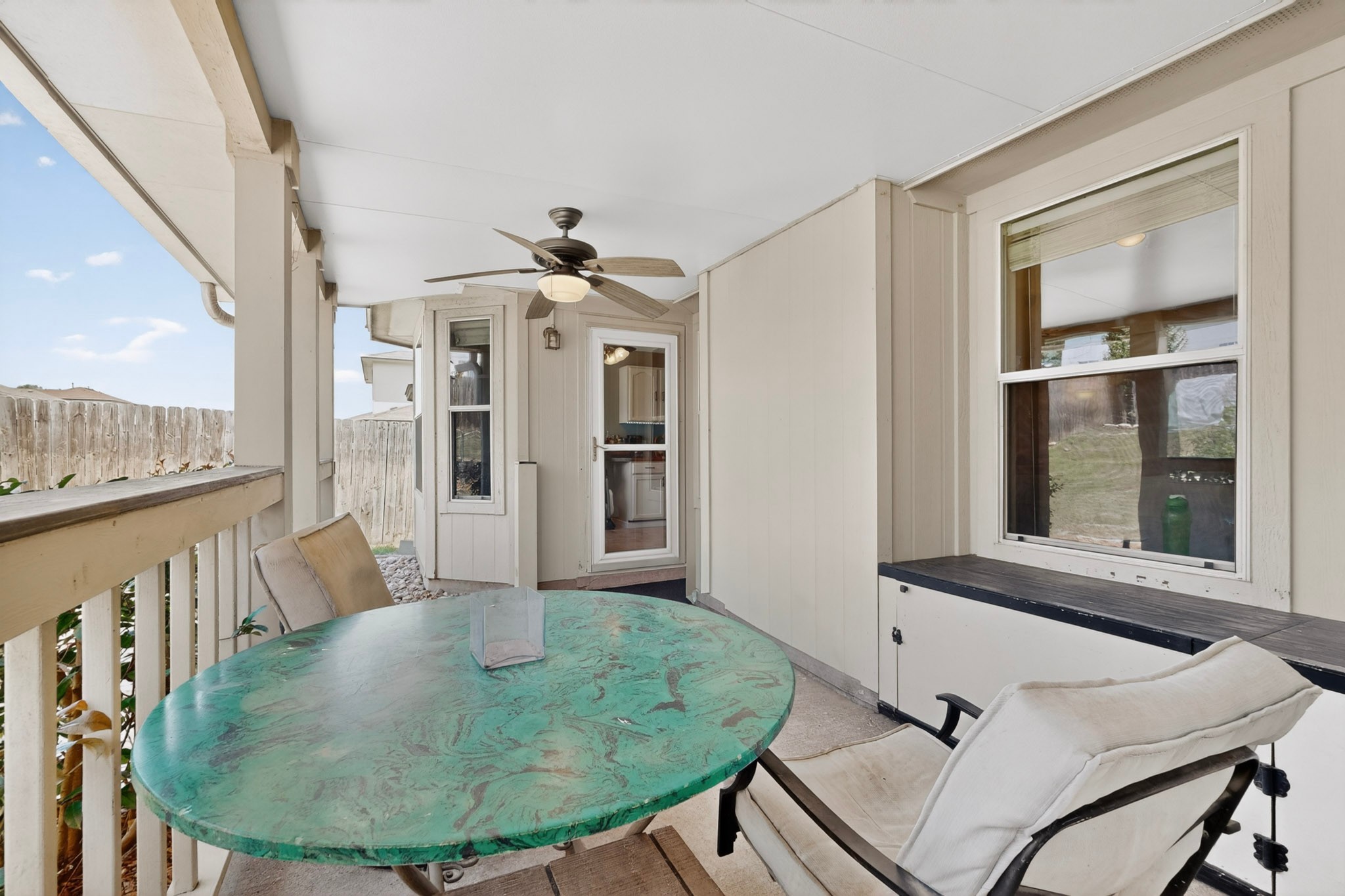 15104 Mimebark Way Austin, TX 78724 - Photo 34 of 38 Covered patio featuring a ceiling fan, white railings, and a privacy fence