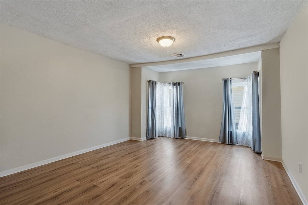 196 Irving Street Fall River, MA 02723 - Photo 31 of 34 a view of an empty room with wooden floor