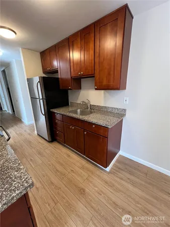 a spacious bathroom with a granite countertop sink and a mirror