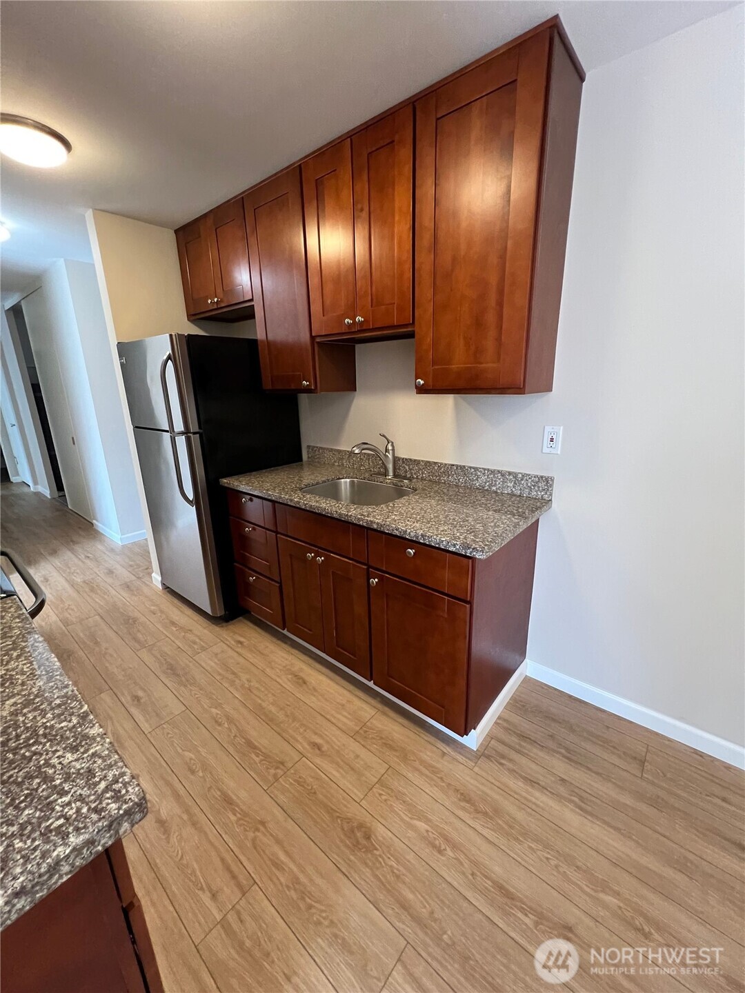 3326 Lombard Avenue, Unit 3 Everett, WA 98201 - Photo 4 of 10 a spacious bathroom with a granite countertop sink and a mirror