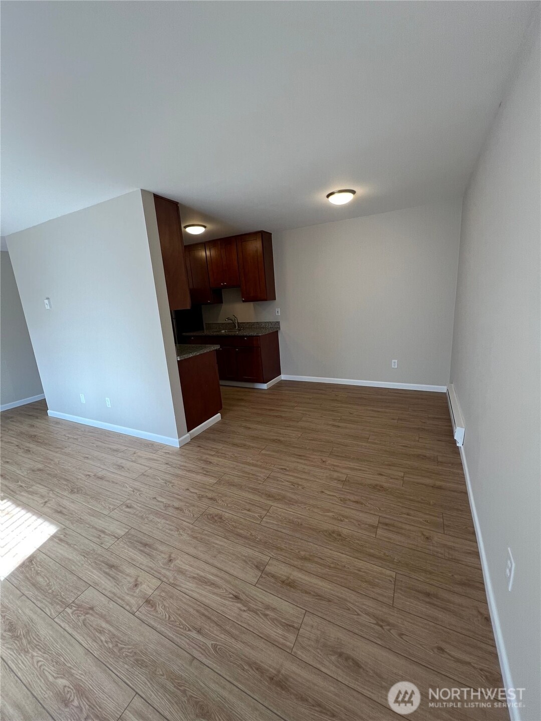3326 Lombard Avenue, Unit 3 Everett, WA 98201 - Photo 5 of 10 a view of a room with wooden floor and kitchen