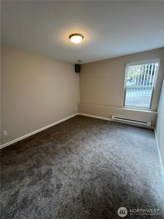 an empty room with a empty space and windows