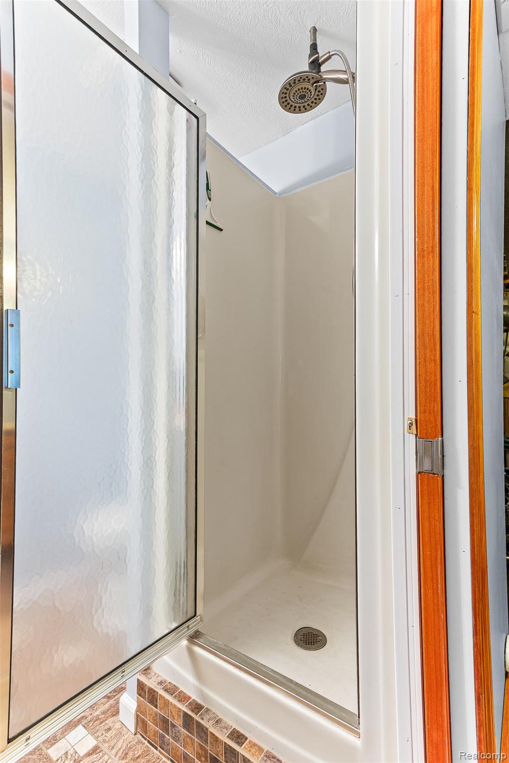 961 Jolly Road Okemos, MI 48864 - Photo 17 of 29 Full bathroom with a shower stall and a textured ceiling
