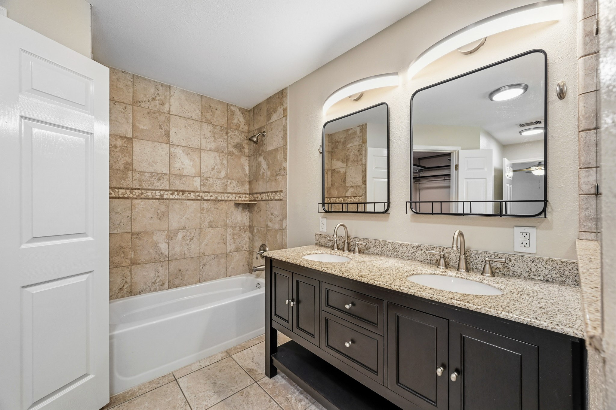 3602 Sweet Gum Spring, TX 77388 - Photo 18 of 30 a bathroom with a granite countertop double vanity sink a mirror and a bathtub