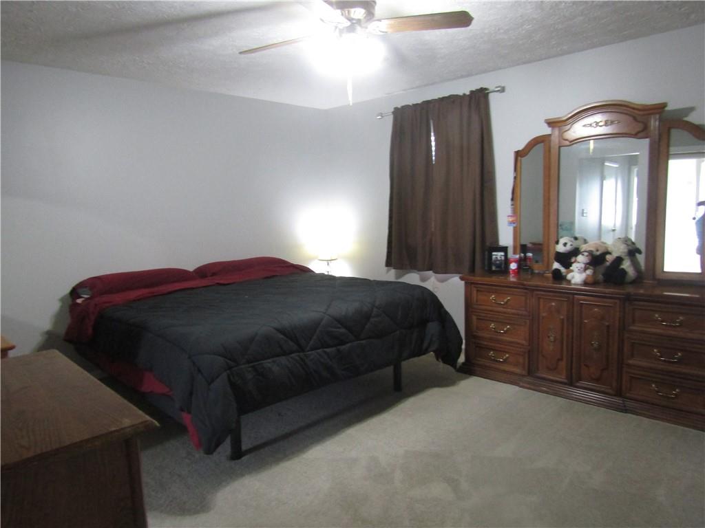 204 Castile Ridge Road Marianna, PA 15345 - Photo 11 of 17 a bedroom with a bed and a chandelier