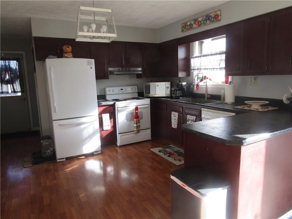 204 Castile Ridge Road Marianna, PA 15345 - Photo 3 of 17 a kitchen with stainless steel appliances granite countertop a refrigerator a stove a sink and a microwave
