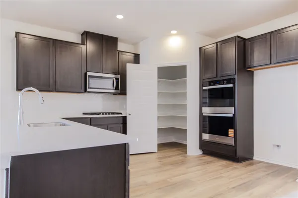 a kitchen with a sink stainless steel appliances and cabinets