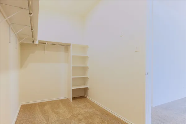 a view of a room with shelf on the wall