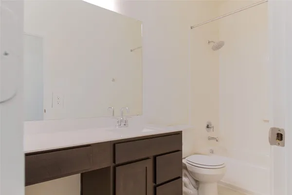 a bathroom with a sink vanity and toilet