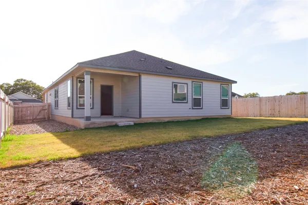 a view of a house with backyard and swimming pool