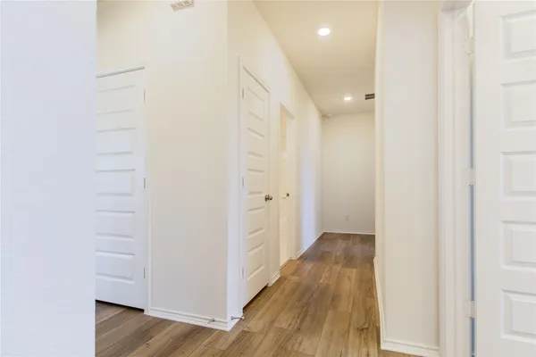 a view of hallway with wooden floor