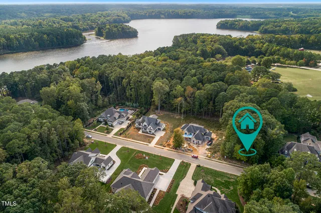 an aerial view of a house with a lake view