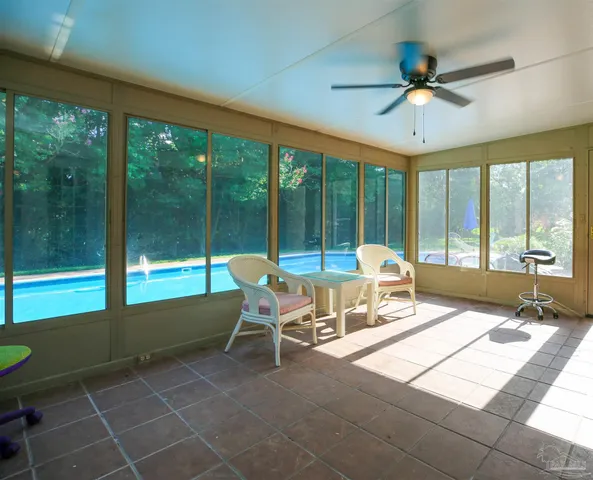 a living room with a floor to ceiling window and a table