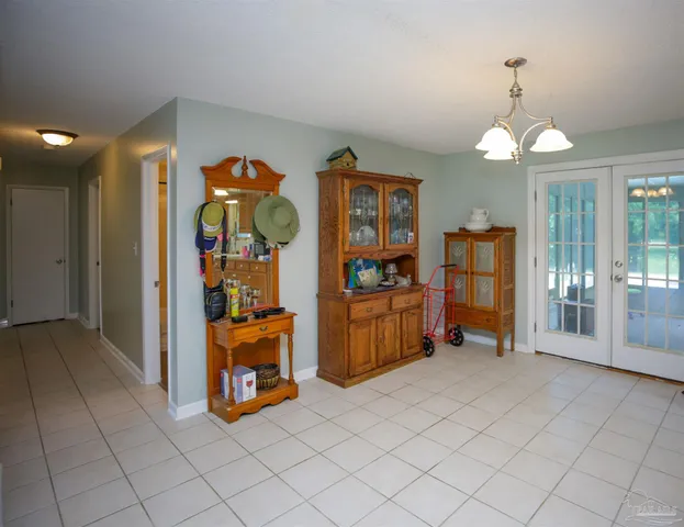 a bedroom with a chair and wooden floor