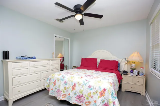 a bedroom with a bed and a television