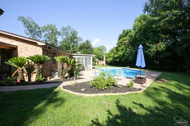 a view of a backyard with plants and a patio