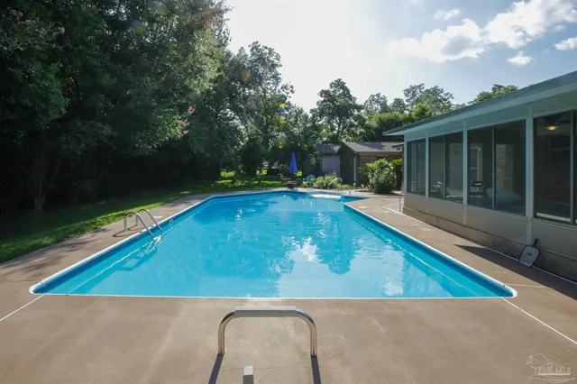 swimming pool view with a seating space