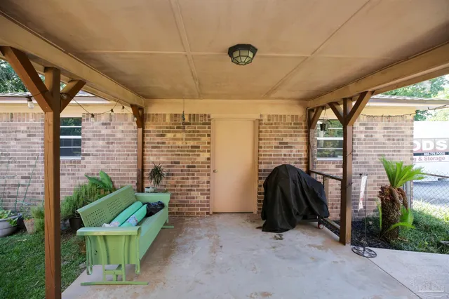 a view of a chair and tables in the patio