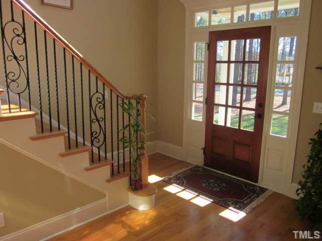 95 Oak Grove Church Road Youngsville, NC 27596 - Photo 11 of 25 Gorgeous two story foyer complete with hardwood floors, hardwood staircase with wrought iron! Very light and bright foyer for greeting your guests!