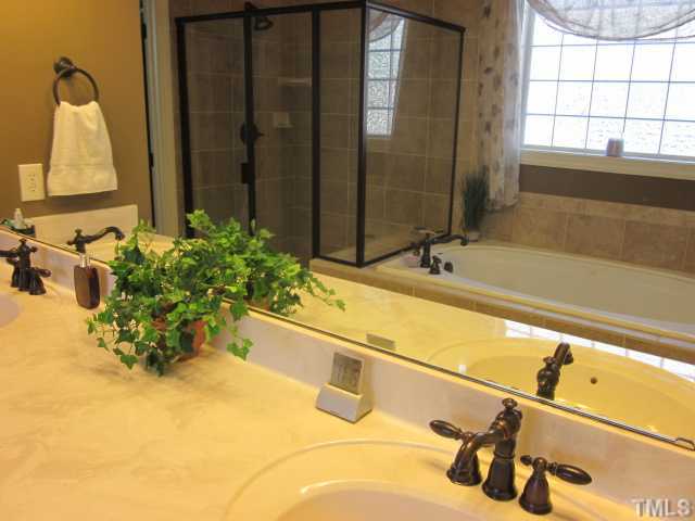 95 Oak Grove Church Road Youngsville, NC 27596 - Photo 17 of 25 The master bath features raised dual vanities, custom tile work, enclosed water closet with elongated toilet, garden tub and separate shower! Don't forget the walk in closet!