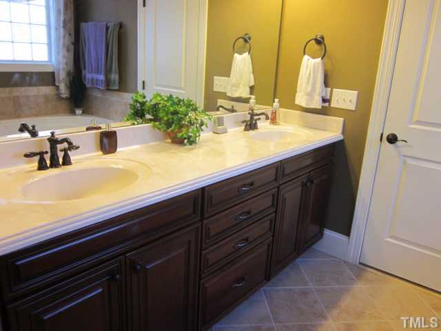 95 Oak Grove Church Road Youngsville, NC 27596 - Photo 18 of 25 Gorgeous master bath features raised dual vanities, custom tile work, garden tub & separate shower, enclosed water closet with elongated toilet! Great walk in closet!