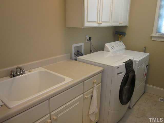95 Oak Grove Church Road Youngsville, NC 27596 - Photo 19 of 25 Here is the large first floor laundry room in your new home! Features include tile floor and mud sink with plenty of room for all of your laundry needs!