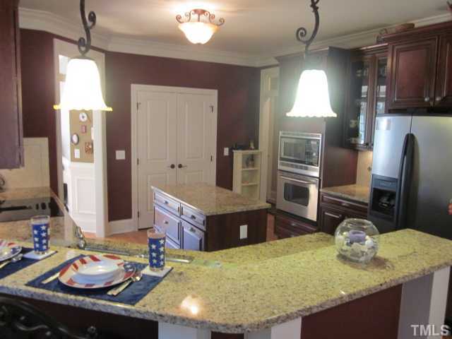 95 Oak Grove Church Road Youngsville, NC 27596 - Photo 8 of 25 This is one awesome kitchen! Plenty of room for two cook's to prepare meals together! Kitchen features include center island, eat at bar, pantry and under cabinet lighting!