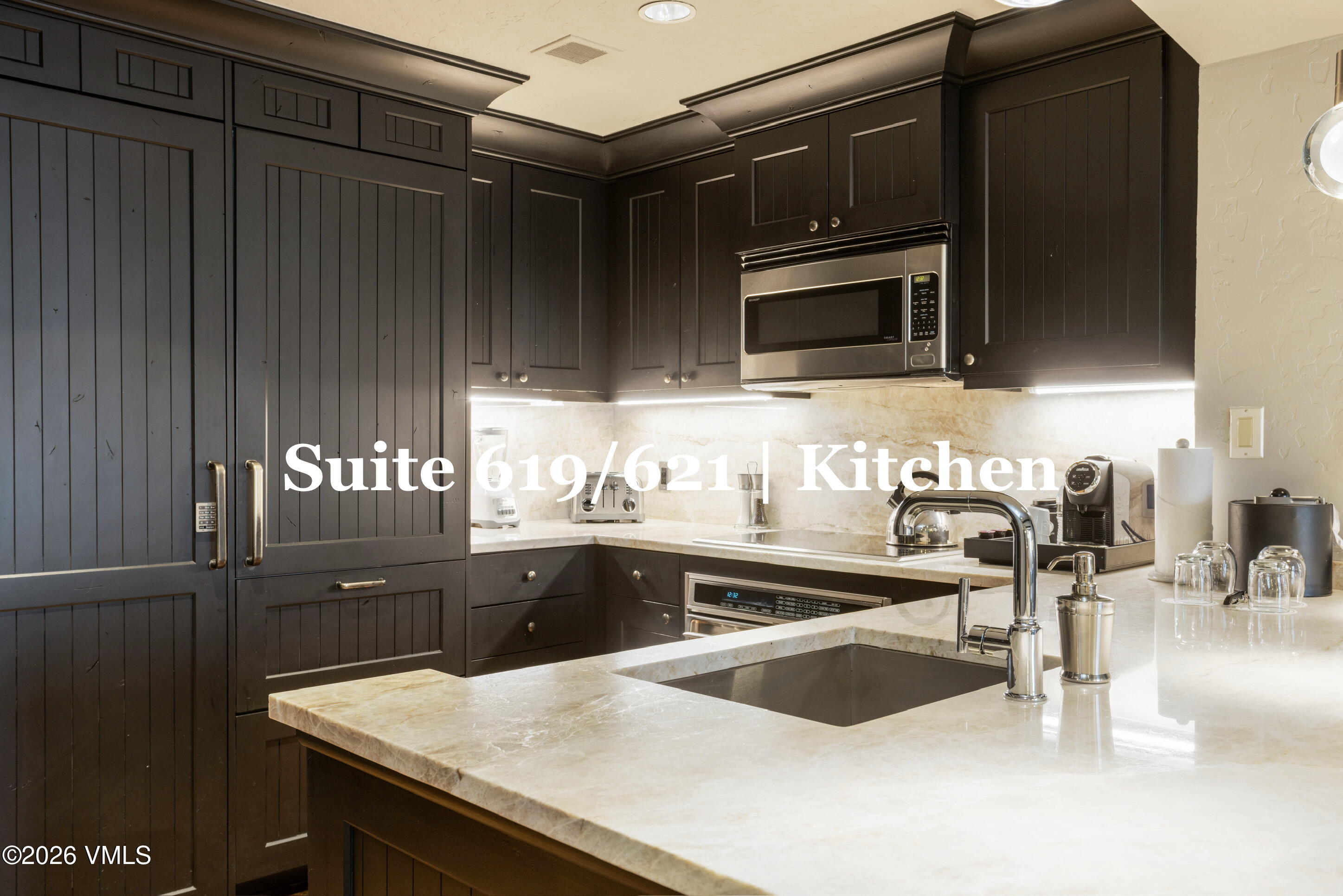 130 Daybreak Ridge Road, Unit HS619 Avon, CO 81620 - Photo 24 of 75 a kitchen with granite countertop a sink and stainless steel appliances