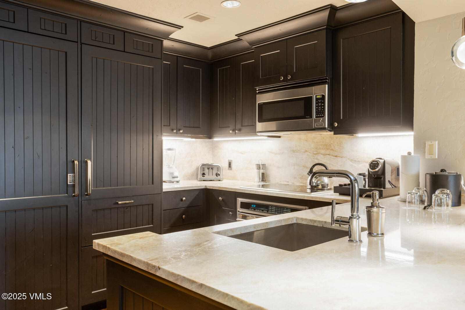 130 Daybreak Ridge Road, Unit HS619 Avon, CO 81620 - Photo 25 of 75 a kitchen with granite countertop a sink and stainless steel appliances