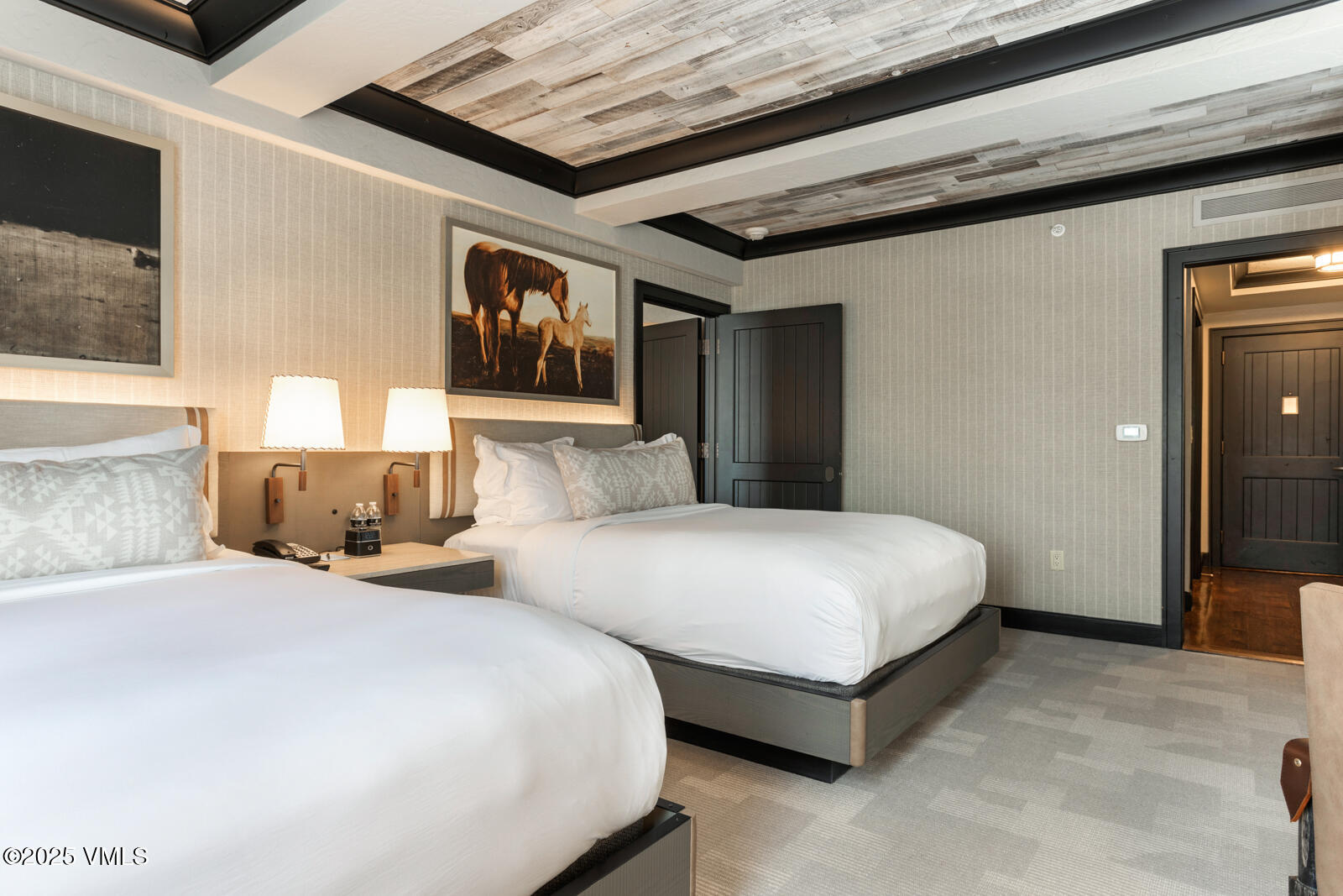 130 Daybreak Ridge Road, Unit HS619 Avon, CO 81620 - Photo 55 of 75 a spacious bedroom with two beds and painting on the wall