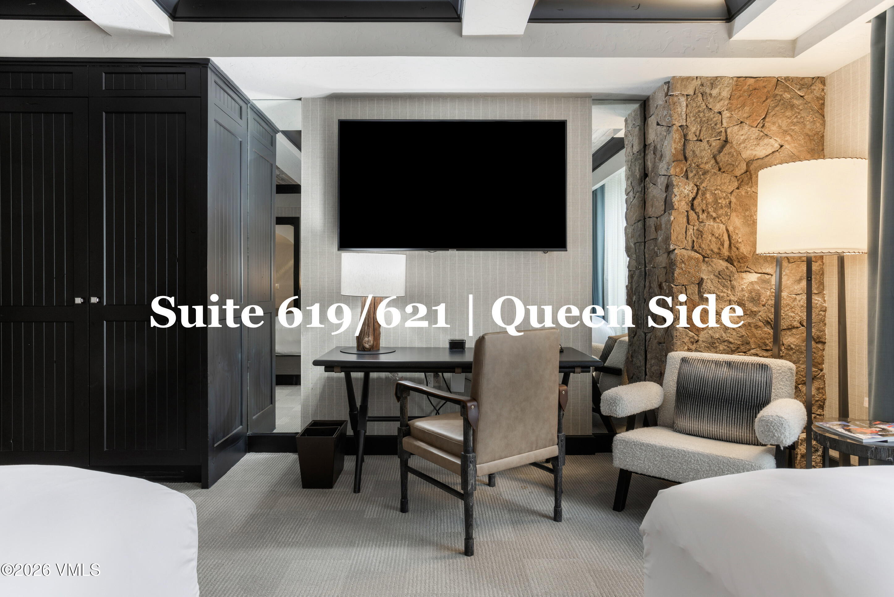 130 Daybreak Ridge Road, Unit HS619 Avon, CO 81620 - Photo 56 of 75 a living room with furniture a flat screen tv and a painting on the wall