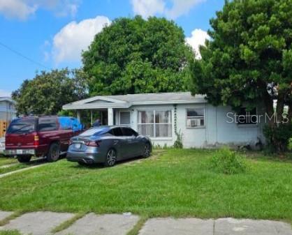 a view of house with backyard