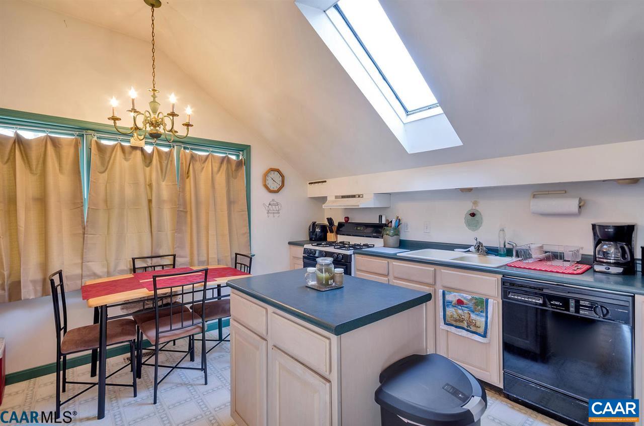 2138 Jacks Shop Road Rochelle, VA 22738 - Photo 25 of 31 a kitchen with a stove a table and chairs in it