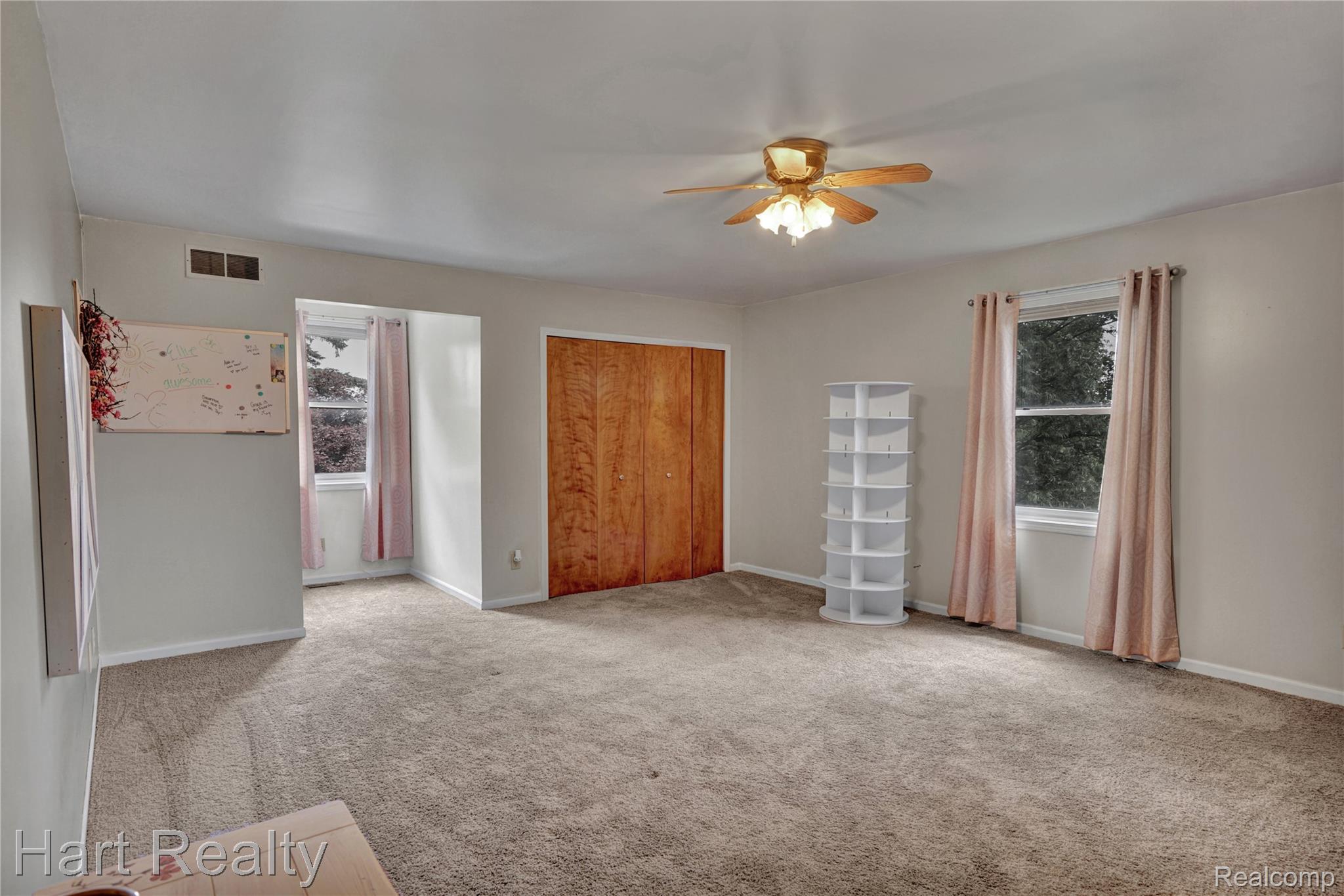 7167 Brown School Road North Branch, MI 48461 - Photo 33 of 51 Spacious room featuring neutral carpeting, light gray wall paint, and multiple windows