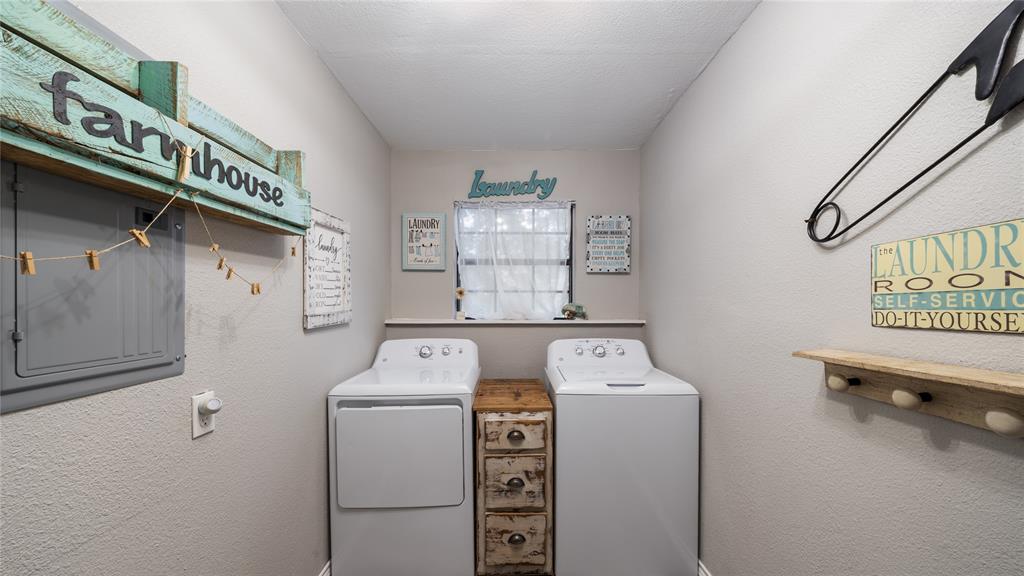 14260 North 3rd Street Scurry, TX 75158 - Photo 12 of 13 Laundry room with a textured wall, washer and clothes dryer, and a textured ceiling