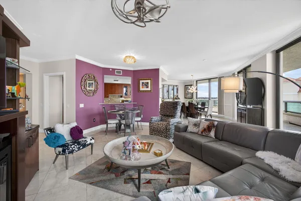 a view of a dining room with furniture and a chandelier